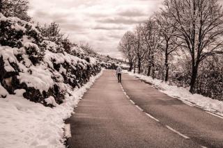 Car fitted with snow chains on a snow covered road in the French Alps